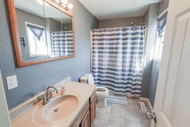 full bath with tile patterned floors, visible vents, toilet, a textured ceiling, and vanity