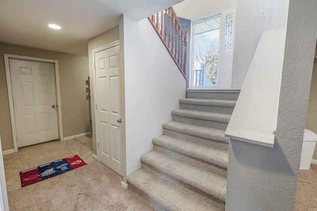 staircase featuring tile patterned flooring, recessed lighting, baseboards, and carpet floors