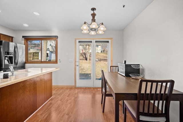 dining room with a chandelier, recessed lighting, and light wood-type flooring