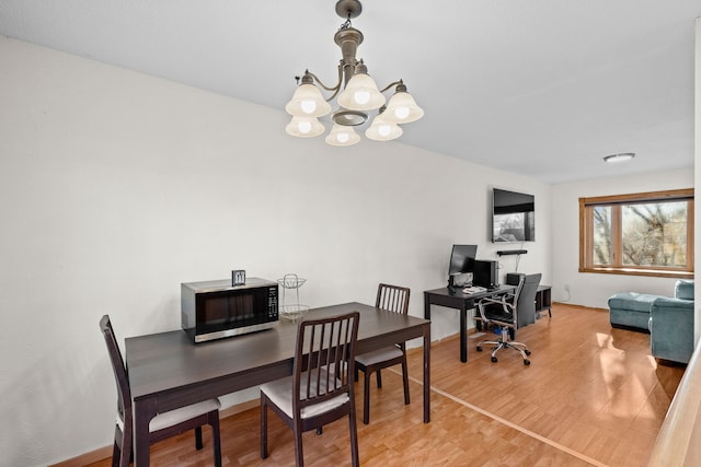 office area featuring light wood-type flooring, baseboards, and a chandelier