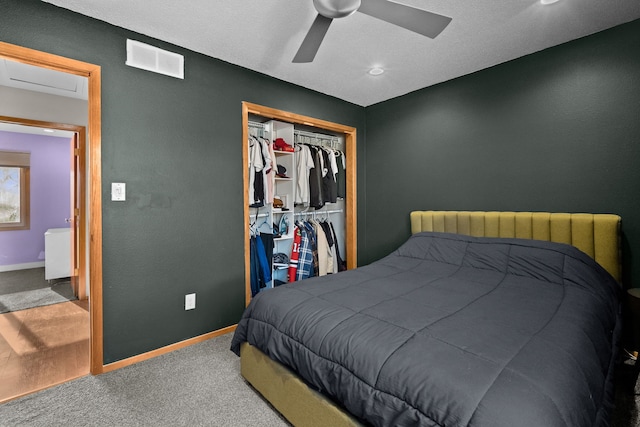 carpeted bedroom with a closet, visible vents, radiator heating unit, and baseboards