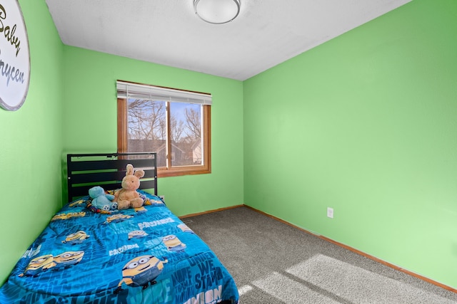 unfurnished bedroom featuring carpet and baseboards