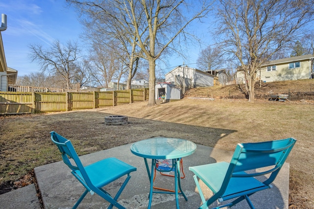 view of yard with an outdoor structure, a fire pit, and fence