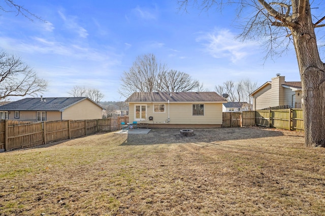 back of house with a yard, a patio, and a fenced backyard