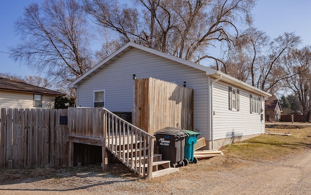 rear view of property featuring fence