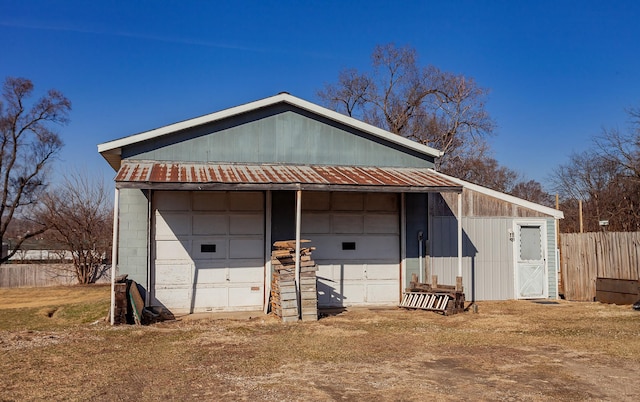 detached garage featuring fence