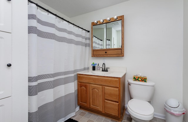 bathroom with curtained shower, toilet, vanity, and a textured ceiling