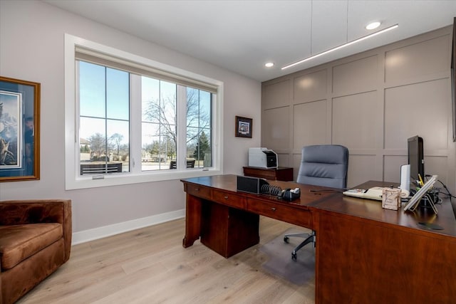 home office with a decorative wall, recessed lighting, baseboards, and light wood finished floors