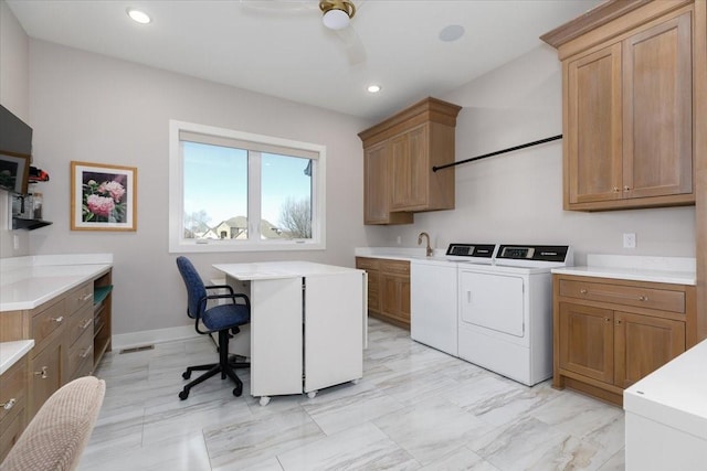 clothes washing area featuring visible vents, washing machine and dryer, recessed lighting, cabinet space, and a sink