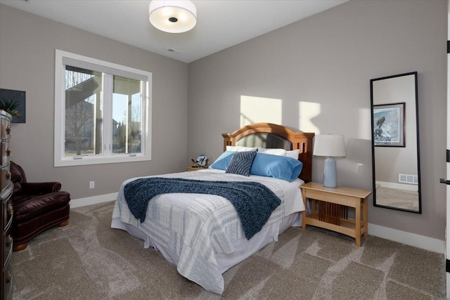 bedroom with lofted ceiling, carpet flooring, baseboards, and visible vents