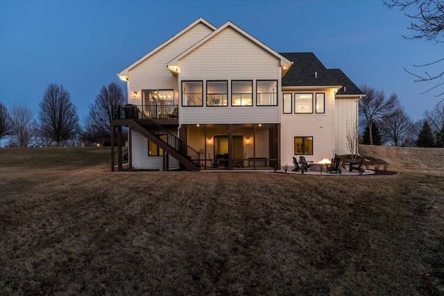 rear view of house with stairs, a patio, a deck, and a yard