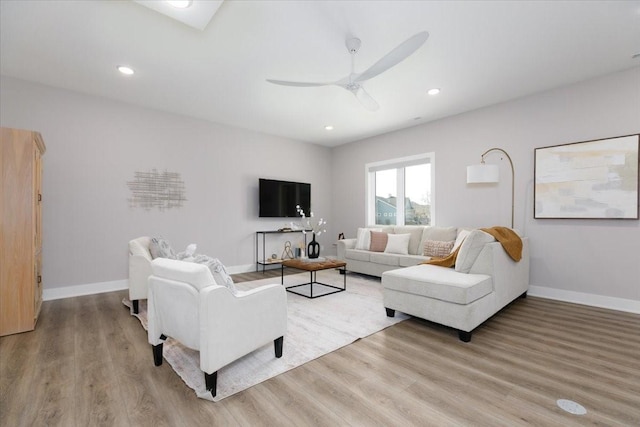 living area with recessed lighting, baseboards, light wood-style floors, and ceiling fan