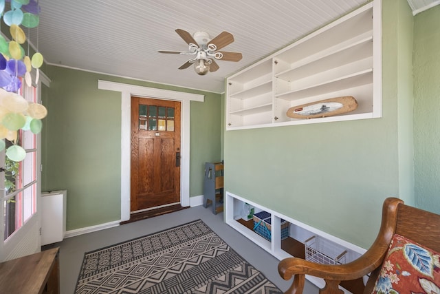 interior space featuring a ceiling fan and baseboards