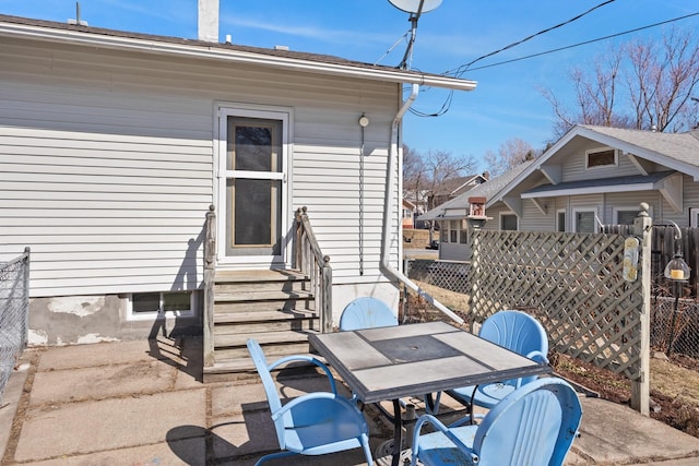 view of patio / terrace with entry steps, outdoor dining area, and fence