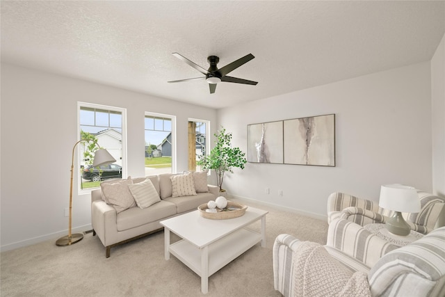 1506 E Girard Ave, Indianola, IA 50125 - living area with a ceiling fan, baseboards, light carpet, and a textured ceiling