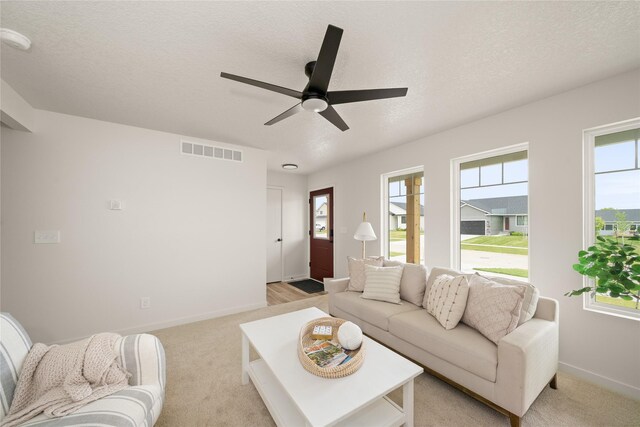 1506 E Girard Ave, Indianola, IA 50125 - living room with ceiling fan, baseboards, plenty of natural light, and a textured ceiling