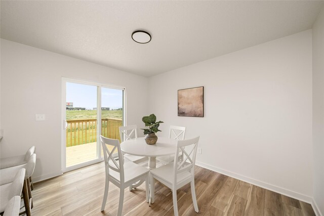 1506 E Girard Ave, Indianola, IA 50125 - dining space featuring light wood-type flooring and baseboards
