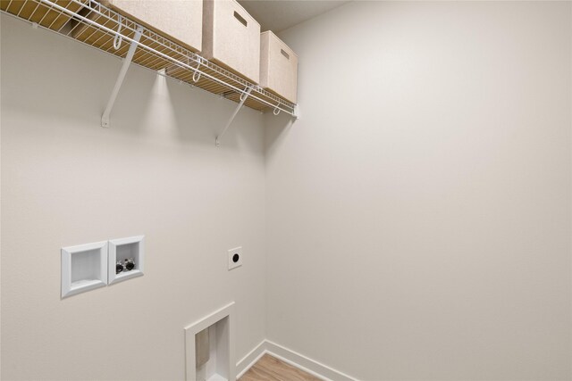 1506 E Girard Ave, Indianola, IA 50125 - washroom with electric dryer hookup, baseboards, hookup for a washing machine, and light wood-type flooring