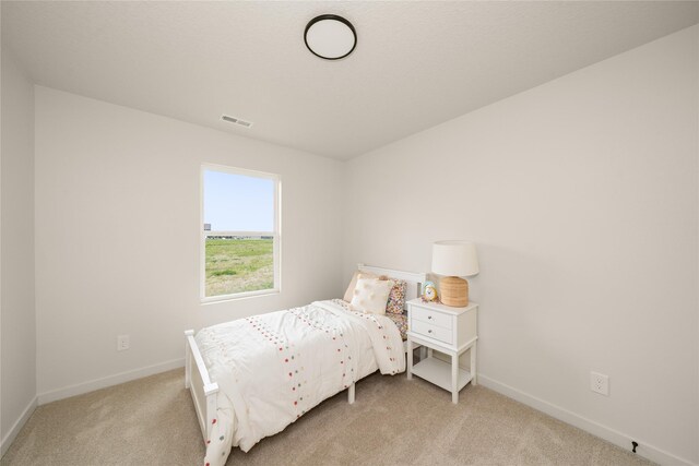 1506 E Girard Ave, Indianola, IA 50125 - bedroom with light colored carpet and baseboards