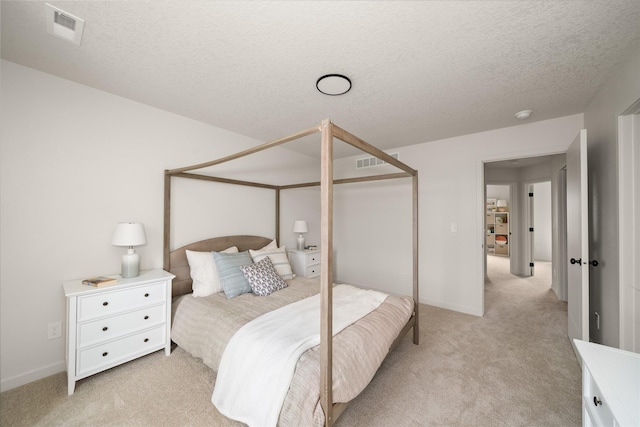 1506 E Girard Ave, Indianola, IA 50125 - bedroom with light colored carpet, a textured ceiling, and baseboards