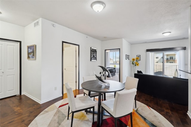 dining room with visible vents, baseboards, and wood finished floors