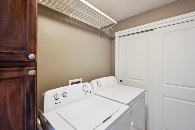 clothes washing area with washing machine and dryer and laundry area