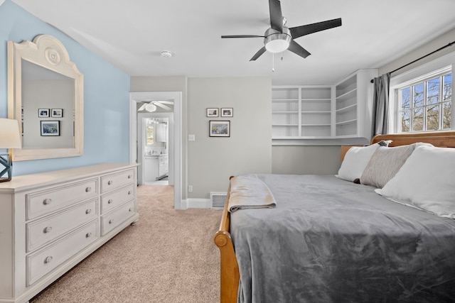 bedroom featuring visible vents, light colored carpet, ceiling fan, and multiple windows