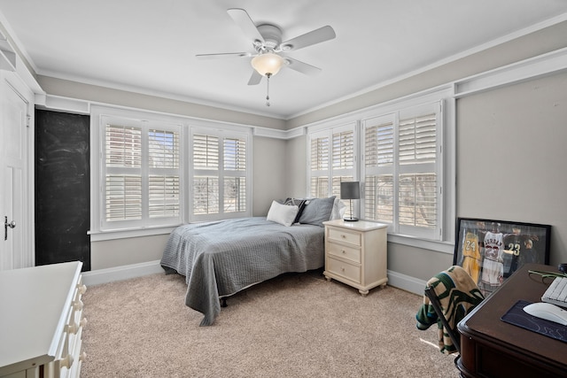 bedroom with light carpet, ceiling fan, baseboards, and ornamental molding