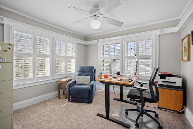 home office featuring carpet floors, baseboards, a wealth of natural light, and ornamental molding