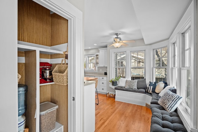 sunroom featuring ceiling fan