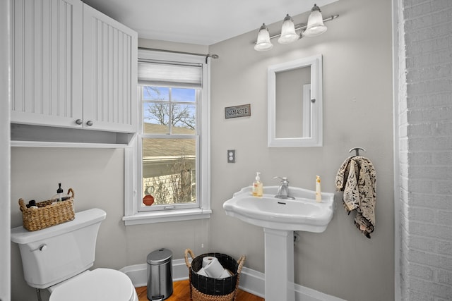 bathroom with baseboards and toilet