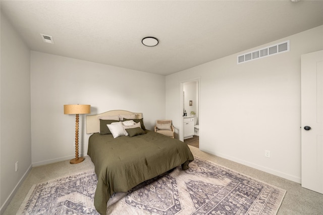 1502 E Girard Ave, Indianola, IA 50125 - carpeted bedroom featuring ensuite bath and baseboards