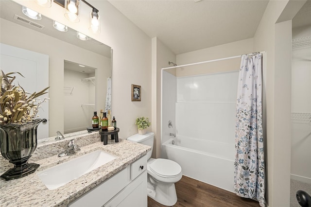 1502 E Girard Ave, Indianola, IA 50125 - full bath featuring toilet, vanity, shower / bath combo, wood finished floors, and a walk in closet