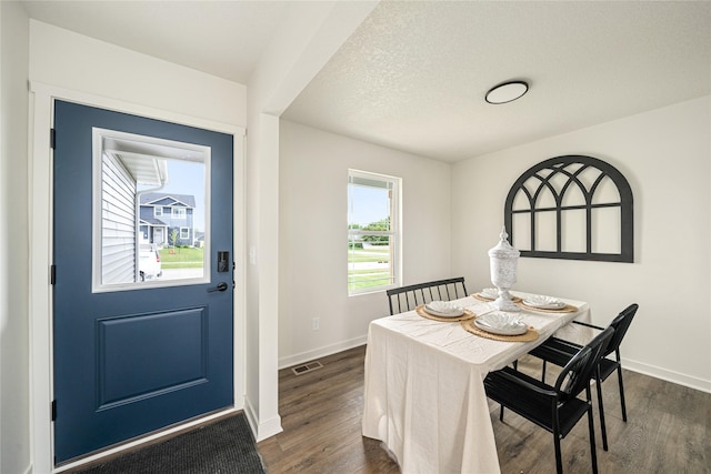 1502 E Girard Ave, Indianola, IA 50125 - dining area with dark wood-style floors and baseboards