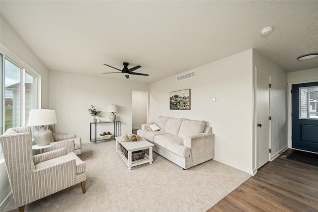 1502 E Girard Ave, Indianola, IA 50125 - living room featuring wood finished floors, a ceiling fan, and baseboards