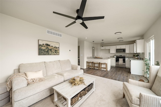 1502 E Girard Ave, Indianola, IA 50125 - living room with dark wood-type flooring and ceiling fan