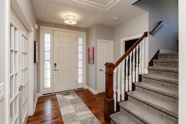 entryway featuring baseboards, dark wood-style floors, and stairs