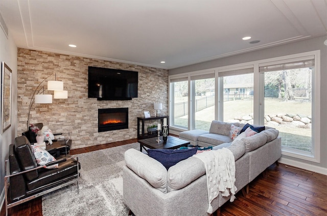 living room with plenty of natural light, dark wood finished floors, and a fireplace