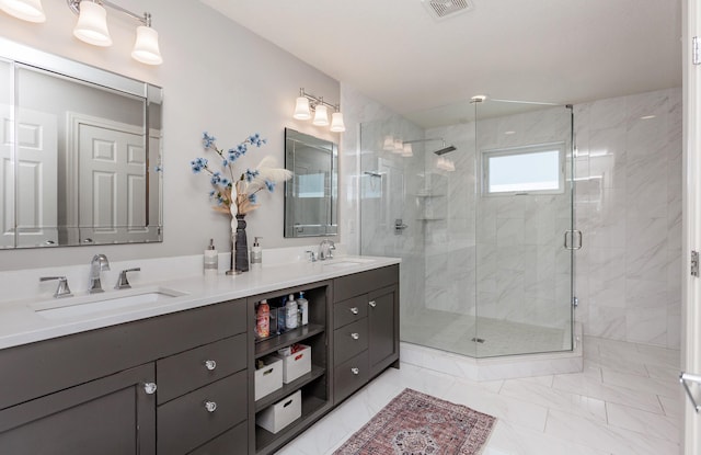 bathroom featuring a sink, visible vents, marble finish floor, and a shower stall