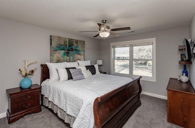 carpeted bedroom featuring visible vents, ceiling fan, and baseboards