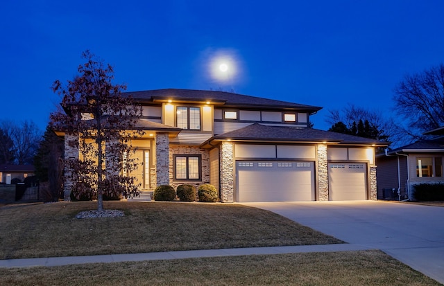 prairie-style home with concrete driveway, an attached garage, stone siding, and stucco siding