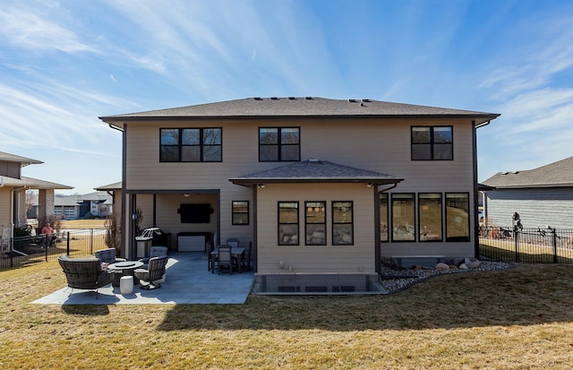 back of property with a yard, a patio area, and fence