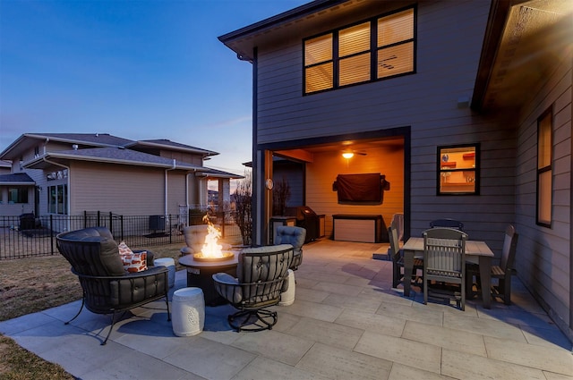 view of patio / terrace with a fire pit and fence