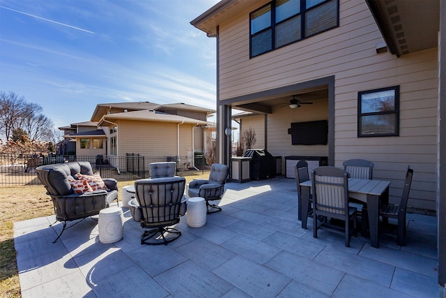 view of patio / terrace with grilling area, outdoor dining space, a ceiling fan, and fence