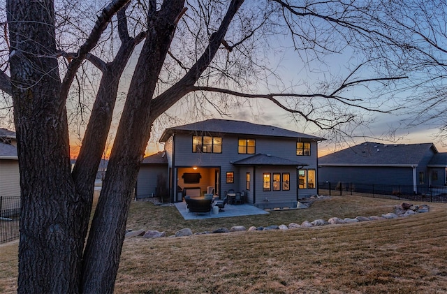 back of house with a patio area, a lawn, and a fenced backyard