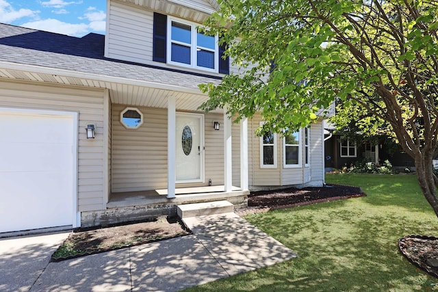 doorway to property with covered porch, a shingled roof, a lawn, and a garage