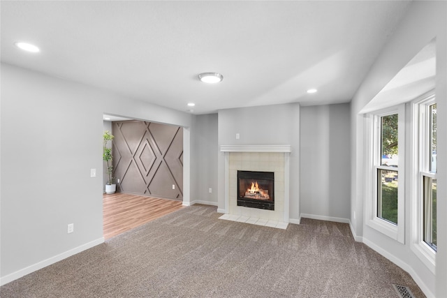 unfurnished living room featuring carpet flooring, recessed lighting, visible vents, and baseboards