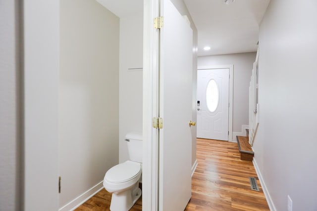 bathroom featuring visible vents, baseboards, and wood finished floors