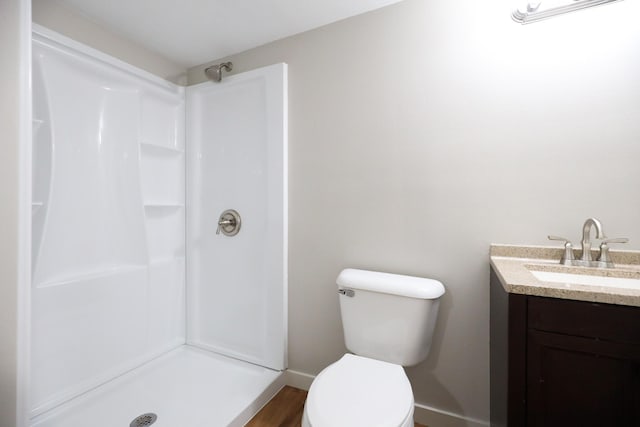 full bathroom featuring a shower, toilet, and vanity