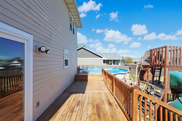 wooden terrace featuring a fenced in pool